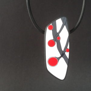 Handmade necklace with a single bead showing a graphic flower bud motif in red, on a white background with a charcoal border. It is approximately 2.6 cm wide and 6.4 cm long and hangs on a black adjustable cord.