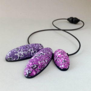 Three bead handmade necklace in magenta andpurple hues.