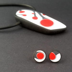 Handmade necklace and stud earrings with abstract flower bud pattern in red, on a white background with a charcoal border.