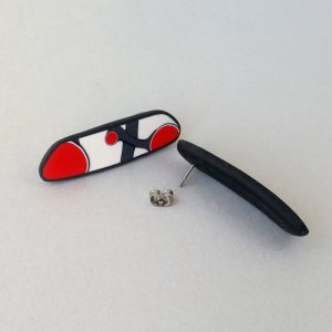 Handmade post earrings with asymmetrical flower bud pattern in red, on a white background with a charcoal border. Surgical stainless steel posts.