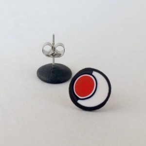 Handmade stud earrings with asymmetrical abstract flower bud pattern in red, on a white background with a charcoal border. Surgical stainless steel posts.