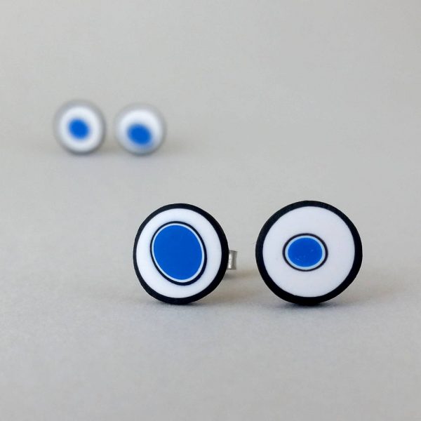 Handmade stud earrings with organic circles of cobalt blue on a white background with a black border.
