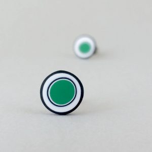 Handmade stud earrings with organic circles of emerald green on a white background with a black border.