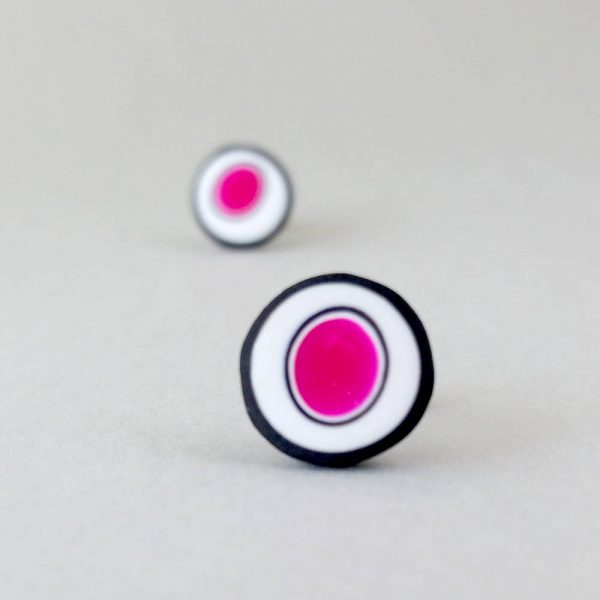 Handmade stud earrings with organic circles of magenta on a white background with a black border.