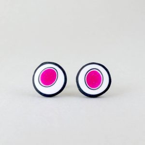 Handmade stud earrings with organic circles of magenta on a white background with a black border.