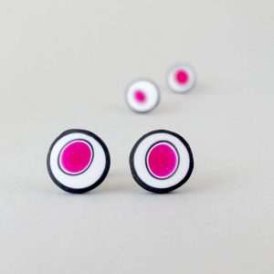 Handmade stud earrings with organic circles of magenta on a white background with a black border.