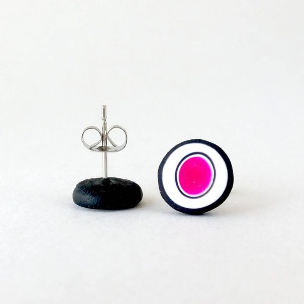 Handmade stud earrings with organic circles of magenta on a white background with a black border.