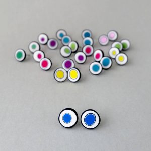 Handmade stud earrings with organic circles of cobalt blue on a white background with a black border.