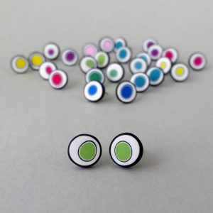 Handmade stud earrings with organic circles of lime green on a white background with a black border.