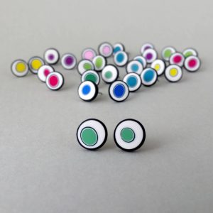 Handmade stud earrings with organic circles of mint green on a white background with a black border.