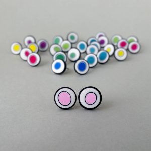 Handmade stud earrings with organic circles of pale pink on a white background with a black border.