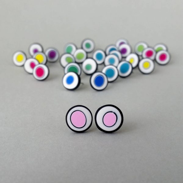 Handmade stud earrings with organic circles of pale pink on a white background with a black border.