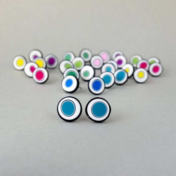 Handmade stud earrings with organic circles of teal blue on a white background with a black border.