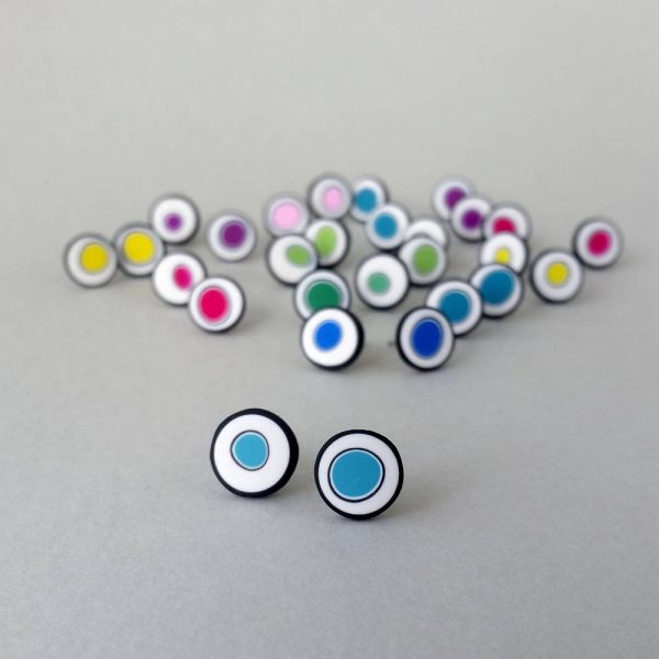 Handmade stud earrings with organic circles of turquoise on a white background with a black border.