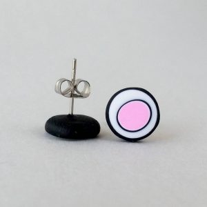 Handmade stud earrings with organic circles of pale pink on a white background with a black border.