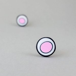Handmade stud earrings with organic circles of pale pink on a white background with a black border.