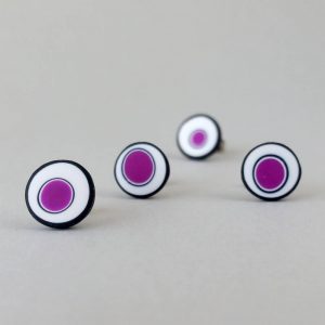 Handmade stud earrings with organic circles of purple on a white background with a black border.