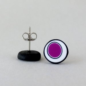 Handmade stud earrings with organic circles of purple on a white background with a black border.