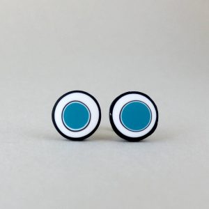 Handmade stud earrings with organic circles of teal blue on a white background with a black border.