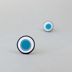 Handmade stud earrings with organic circles of teal blue on a white background with a black border.