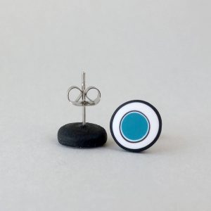 Handmade stud earrings with organic circles of teal blue on a white background with a black border.