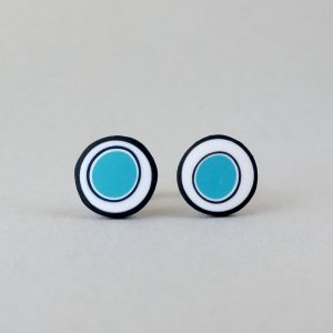 Handmade stud earrings with organic circles of turquoise on a white background with a black border.