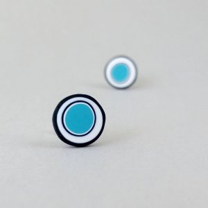 Handmade stud earrings with organic circles of turquoise on a white background with a black border.