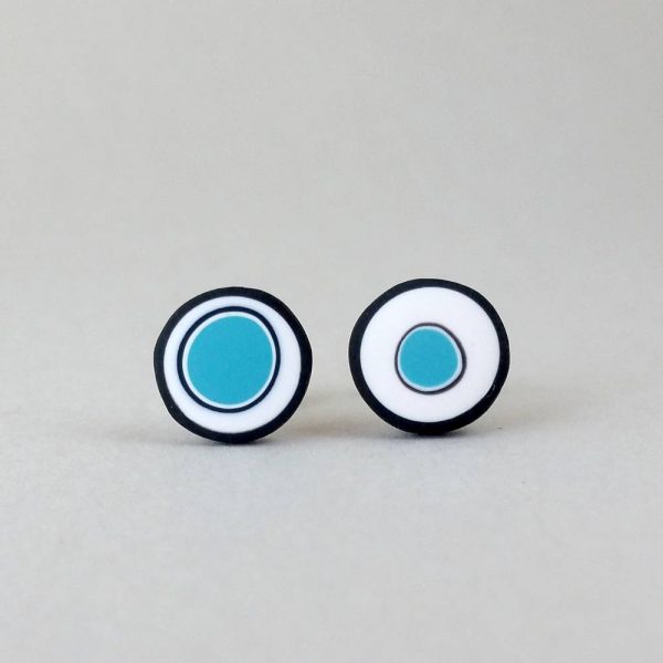 Handmade stud earrings with organic circles of turquoise on a white background with a black border.