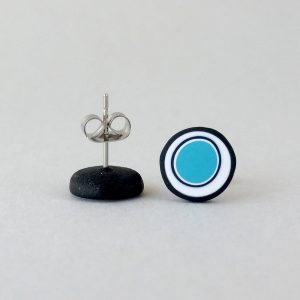 Handmade stud earrings with organic circles of turquoise on a white background with a black border.