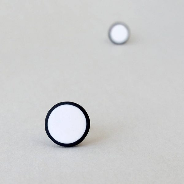 Handmade stud earrings in pure white with a black border.