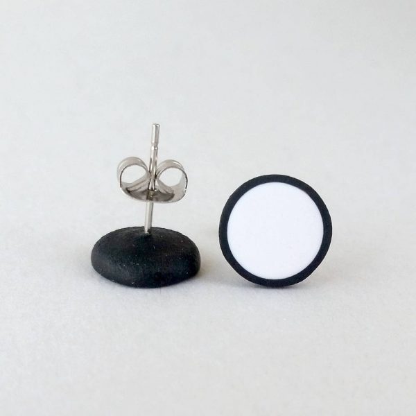 Handmade stud earrings in pure white with a black border.