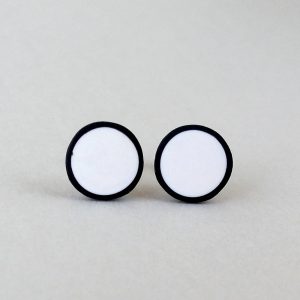 Handmade stud earrings in pure white with a black border.