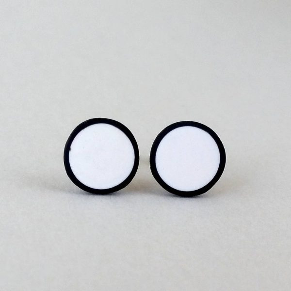 Handmade stud earrings in pure white with a black border.