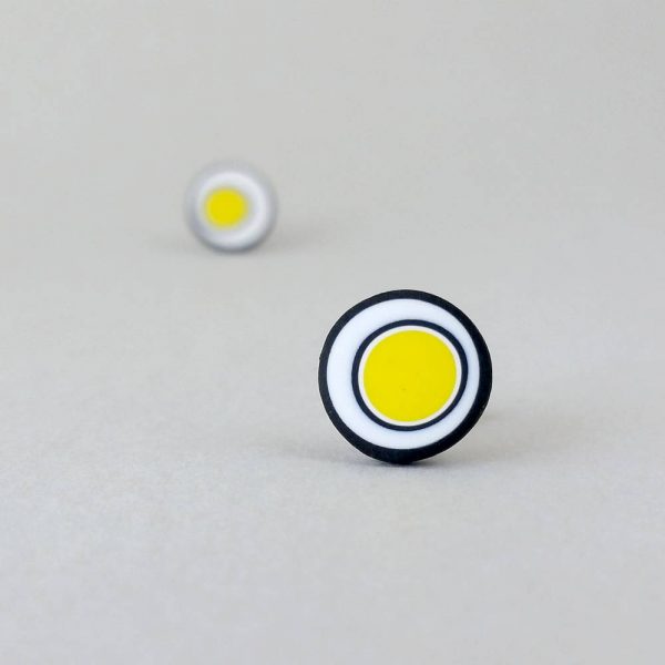 Handmade stud earrings with organic circles of bright yellow on a white background with a black border.