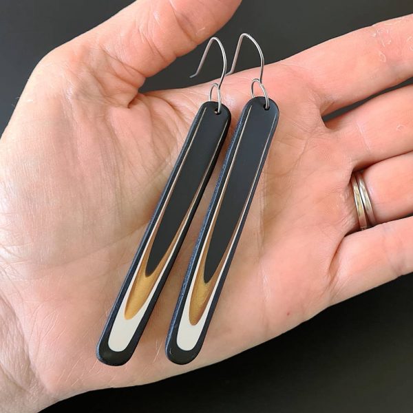 Handmade long dangle earrings with a clean, modern pattern in black, gold and white. Hand crafted titanium earwires.