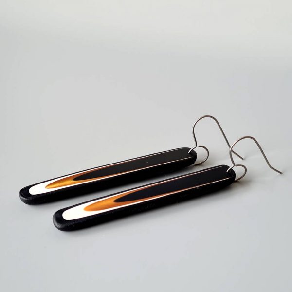 Handmade long dangle earrings with a clean, modern pattern in black, gold and white. Hand crafted titanium earwires.