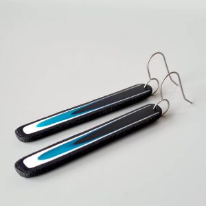 Handmade long dangle earrings with a clean, modern pattern in black, teal blue and white. Hand crafted titanium earwires.