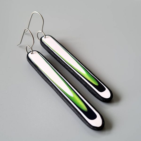 Handmade long dangle earrings with a clean, modern pattern in black, lime green and white. Hand crafted titanium earwires.