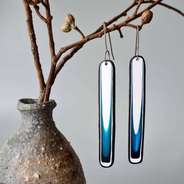 Handmade long dangle earrings with a clean, modern pattern in black, teal blue and white. Hand crafted titanium earwires.