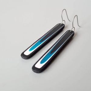 Handmade long dangle earrings with a clean, modern pattern in black, teal blue and white. Hand crafted titanium earwires.