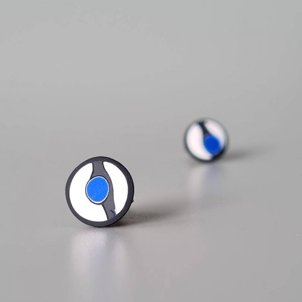 Handmade stud earrings with asymmetrical abstract flower bud pattern in blue tones, on a white background with a charcoal border. Titanium posts.