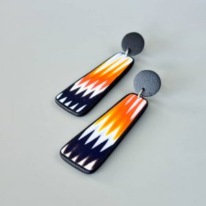 Handmade dangle earrings with zigzag pattern in black, white and orange.