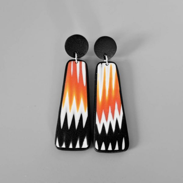 Handmade dangle earrings with zigzag pattern in black, white and orange.