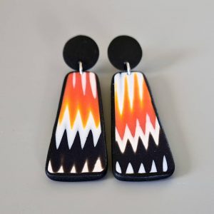 Handmade dangle earrings with zigzag pattern in black, white and orange.